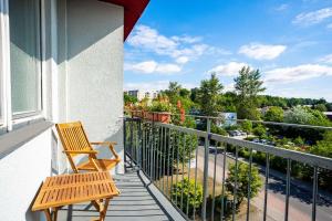 a balcony with two chairs and a view of a city at Soibelmanns Hotel Weimar in Weimar