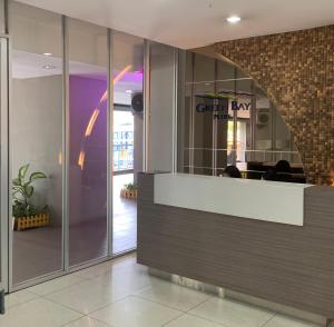 a lobby with a reception desk in a building at Cozy Studio 1BR at Green Bay Pluit Apartment in Jakarta