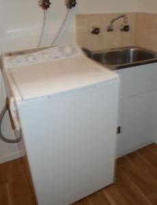a white refrigerator in a kitchen with a sink at Waterfall Cottage in Rosebud