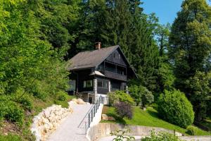 a black house on the side of a hill at Gorgeous Chalet in Bled