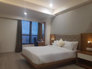 Postel nebo postele na pokoji v ubytování Hotel Grace Galaxy