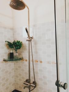 a shower with a shower head in a bathroom at lamphuonghouse in Da Lat