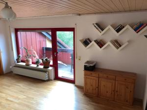 a room with a sliding glass door with books on the wall at Natürlicher Holzkomfort im hessischen Kegelspiel in Hünfeld