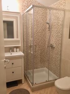 a bathroom with a shower with a toilet and a sink at Villa Dule in Pakoštane