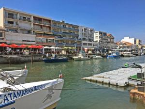 a group of boats docked in a harbor with buildings at Côté Sud in Palavas-les-Flots