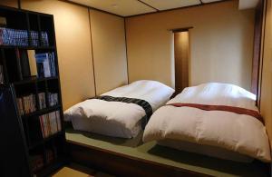 Postel nebo postele na pokoji v ubytování Hakone Kyuan