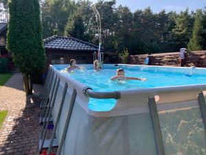 a group of people in a swimming pool at Dom Natura in Zdbice