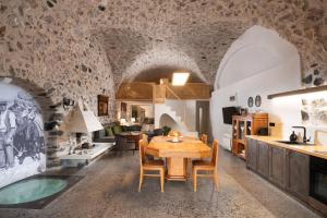 a kitchen and dining room with a table and chairs at Canava Villas #2 in Santorini Private Pool in Emporio