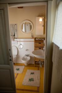 a bathroom with a sink and a toilet at La Casa di Enea in Pistoia