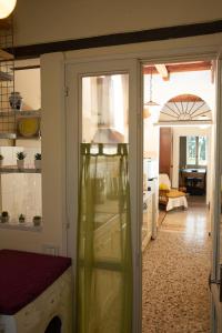 a kitchen with a door open to a room with a washer at La Casa di Enea in Pistoia