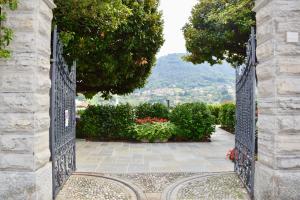 an open gate to a garden with a view at Villa Vitali - Bellagio in Bellagio