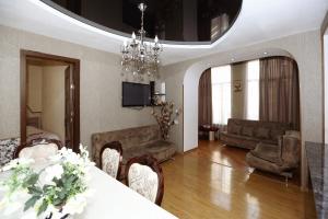 un soggiorno con tavolo, sedie e divano di Lela Apartments a Tbilisi City