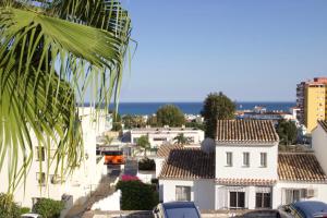 a view of a city with houses and the ocean at Sunny bungalow with sea view nearby Carihuela Beach in Torremolinos