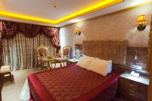 A bed or beds in a room at Grand Ambiance Hotel