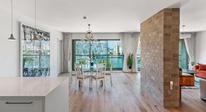 a dining room and living room with a table and chairs at Lagoon Amazing Water Front 3 Bedrooms in Herzliya B
