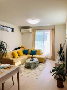 a living room with a couch and a table at Takara House in Tokyo