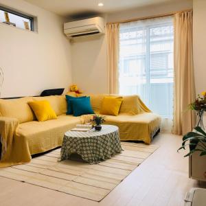 a living room with a couch and a table at Takara House in Tokyo