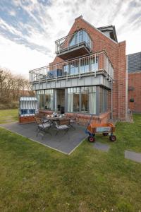 a large brick building with a table and chairs at Dünenstern in Wangerooge