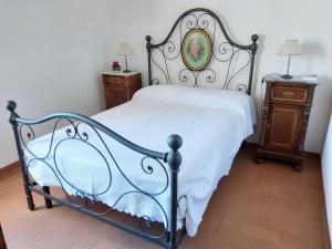 a bedroom with a white bed and two night stands at In centro in Montalcino