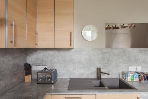 a kitchen with a sink and a counter top at Esslemont Pad in Aberdeen