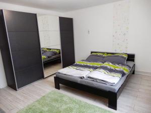 a bedroom with a bed and a large mirror at Apartment for your Holiday in Ramingstein