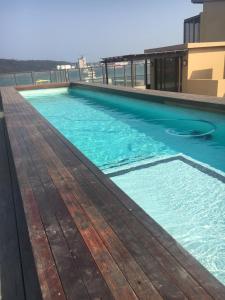 a swimming pool on the roof of a building at Durban Waterfront Apartments in Durban