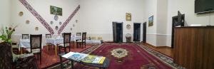 a room with a table and chairs and a podium at Mubina Khiva B&B in Khiva