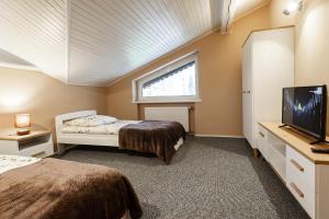 Una cama o camas en una habitación de Apartamenty Pod Gondolą