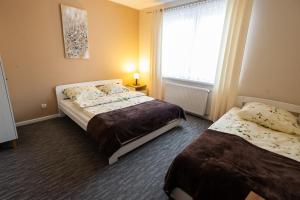 Posteľ alebo postele v izbe v ubytovaní Apartamenty Pod Gondolą