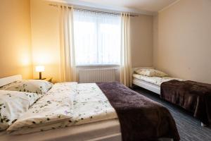 Posteľ alebo postele v izbe v ubytovaní Apartamenty Pod Gondolą