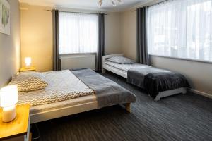 Posteľ alebo postele v izbe v ubytovaní Apartamenty Pod Gondolą