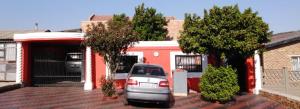 a car parked in a parking lot in front of a house at Madida's Bed and Breakfast in Soweto