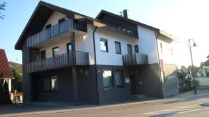 a black and white building on the side of a street at Hotel Glas Schwarzwald in Fluorn