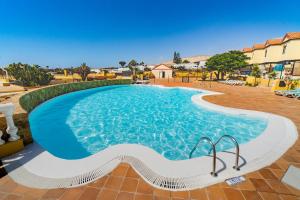 a large swimming pool in a resort at Casa Hugo in Costa Calma
