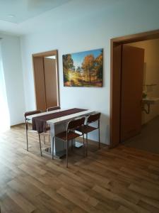 a dining room table with chairs and a painting on the wall at Jura Hotel in Nuremberg +32 photos