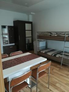 a room with two bunk beds and a table and chairs at Jura Hotel in Nürnberg