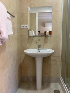 a bathroom with a sink and a mirror at Residencial Lord in Lisbon