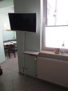 a flat screen tv on a wall in a room at Pension Barghus in Zinnowitz