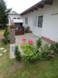 a house with pink flowers in the yard at Pension Barghus in Zinnowitz