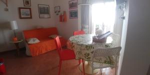a room with a table and chairs and a bed at Casa RoSiLù in Monopoli