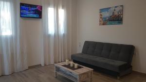 a living room with a couch and a table at Tanyas Cozy House in Kamilari