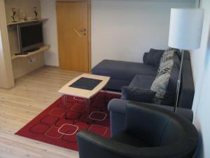 a living room with a couch and a table at Appartement Geisler in Zell am Ziller