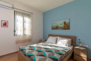 A bed or beds in a room at House Myrtos