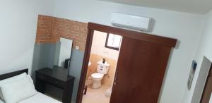 a room with a bathroom with a toilet and a door at Marina's Rooms in Larnaca