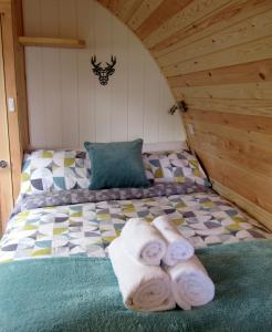 a bedroom with a bed with towels on it at Harlosh Hideaways - Stargazer Pod in Harlosh