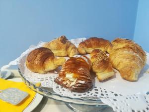 a plate of croissants and pastries on a table at B&B L'Edera di Caterina in Reggio di Calabria