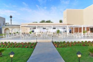 a courtyard with tables and chairs in a building at JAZ Mirabel Resort in Sharm El Sheikh
