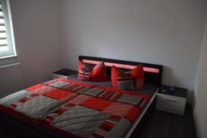 a bedroom with a bed with red pillows on it at „Schönes“ Ferienhaus in Thale
