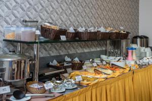 a buffet of food on a table in a restaurant at Tambau Beach Hotel in João Pessoa