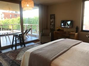 a bedroom with a bed and a balcony at International House Aalter in Aalter